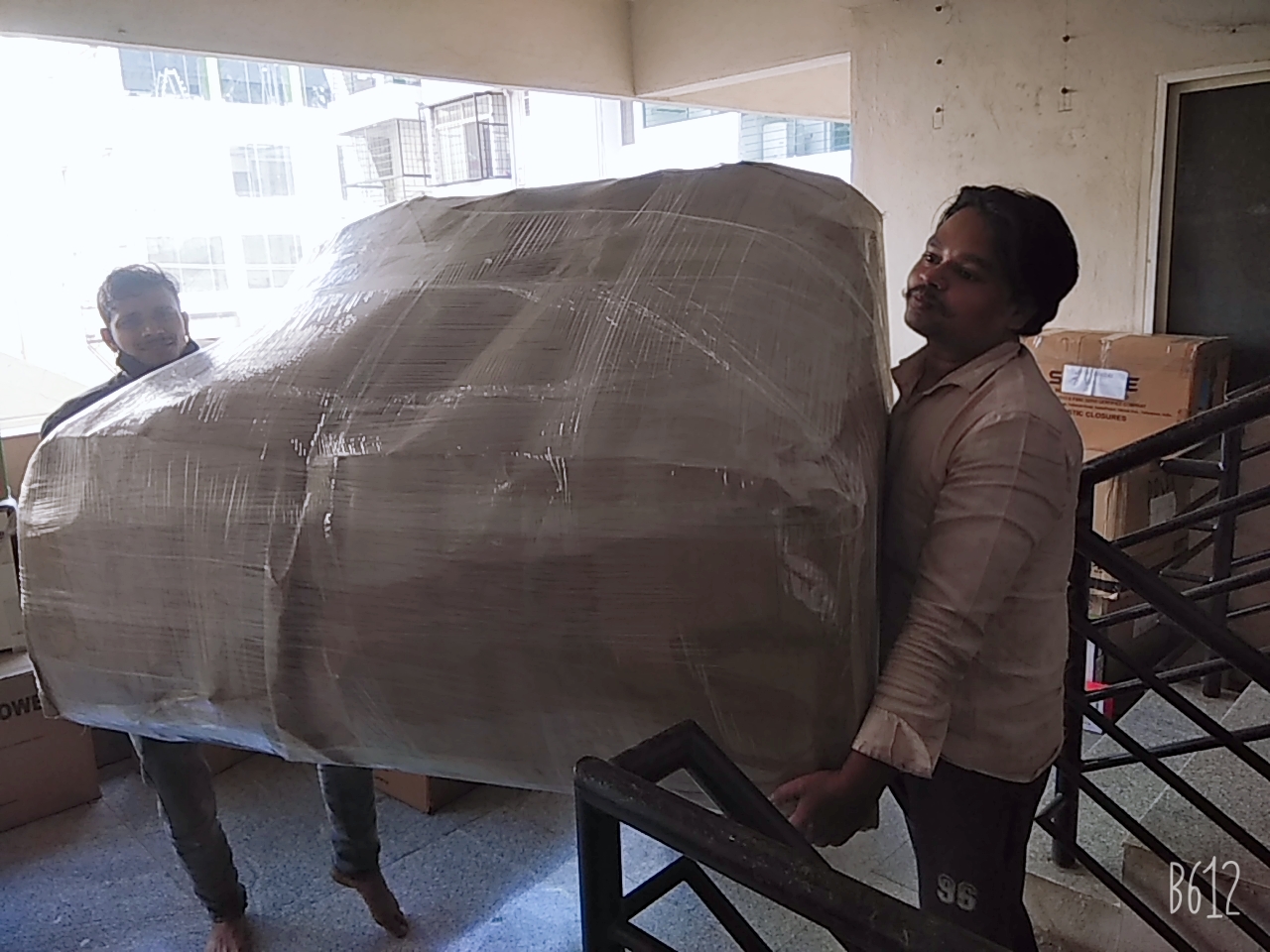 Female entrepreneur talking to movers in new restaurant